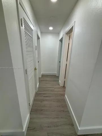 a kitchen with stainless steel appliances granite countertop a refrigerator a stove a sink and a microwave