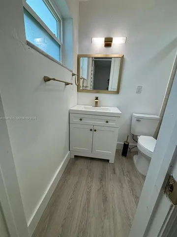 a kitchen with a refrigerator and a sink