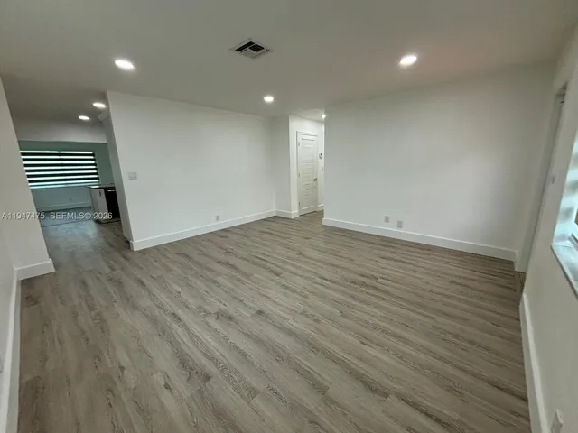 an empty room with an entrance to other room