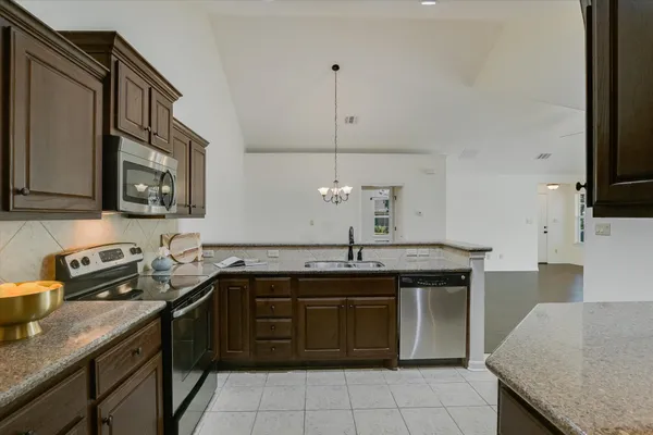 a kitchen with a sink and a stove