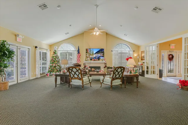 a view of a livingroom with furniture and a flat screen tv