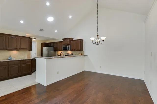 a kitchen with a sink stainless steel appliances and cabinets