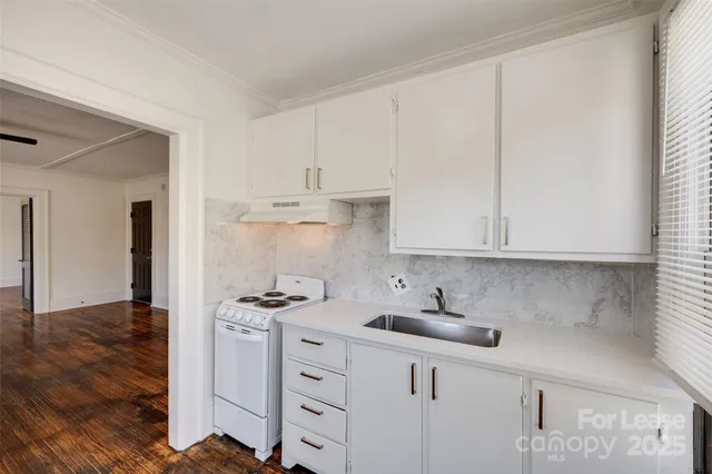 a kitchen with stainless steel appliances white cabinets and a sink