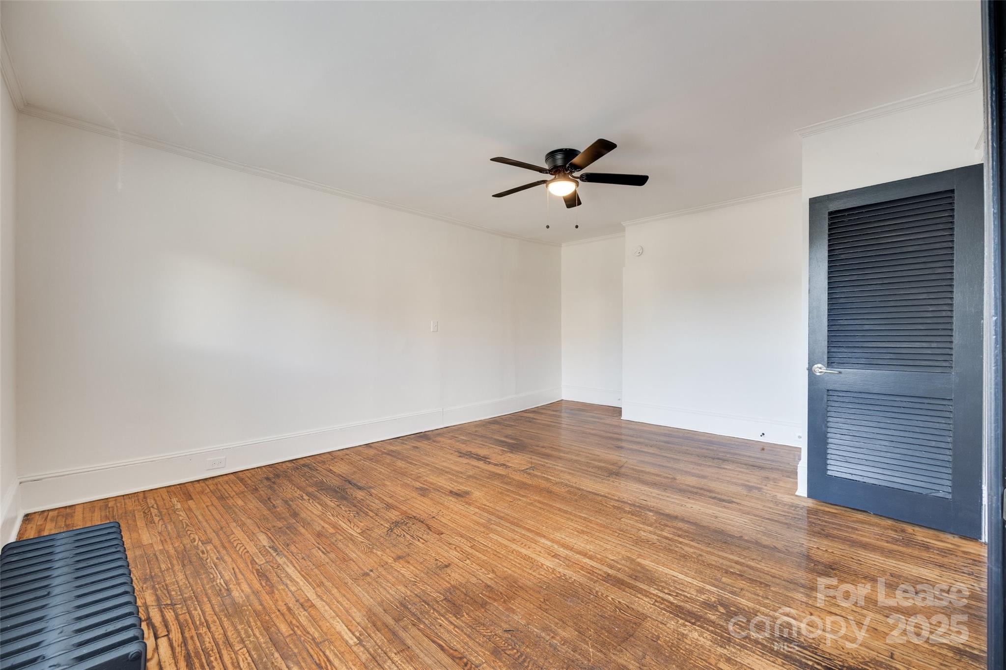 49 Corban Avenue Southwest, Unit 3 Concord, NC 28025 - Photo 12 of 16 a view of empty room with wooden floor and fan