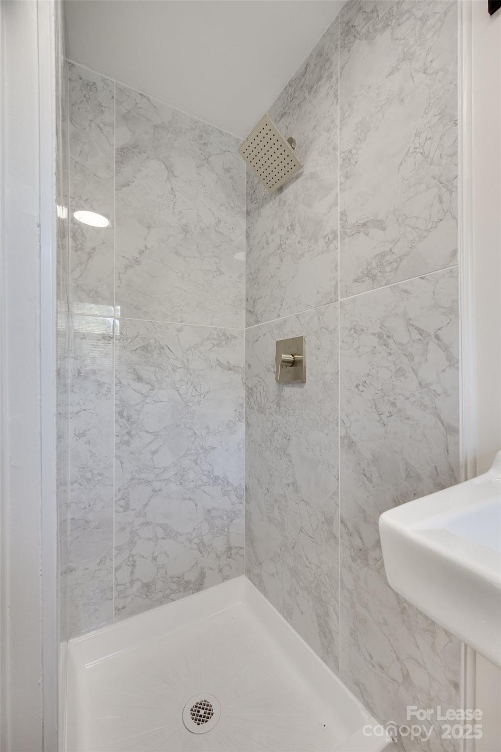 49 Corban Avenue Southwest, Unit 3 Concord, NC 28025 - Photo 16 of 16 a bathroom with a shower and a toilet