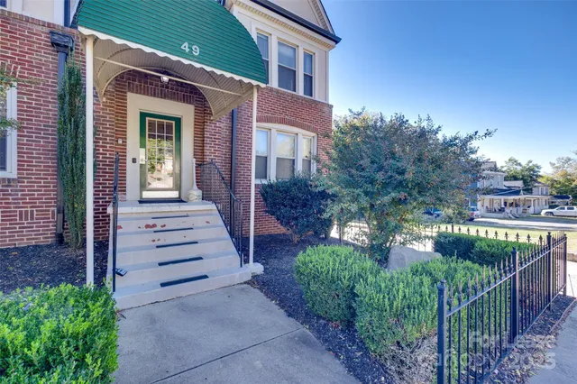 a view of a house with brick walls and windows