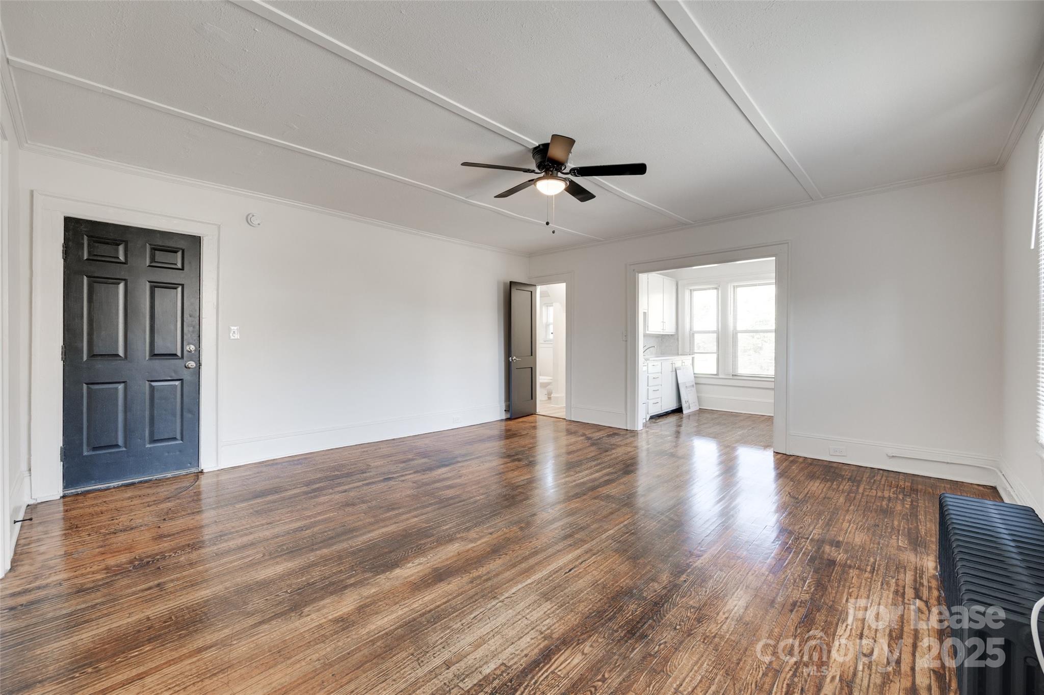 49 Corban Avenue Southwest, Unit 3 Concord, NC 28025 - Photo 6 of 16 a view of empty room with wooden floor and fan