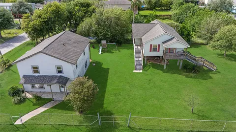 a aerial view of a house with a yard table and chairs
