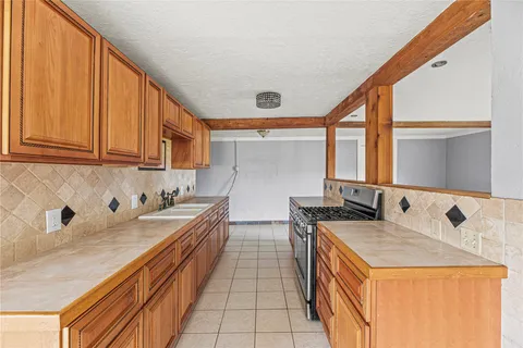 a kitchen with stainless steel appliances sink cabinets and window