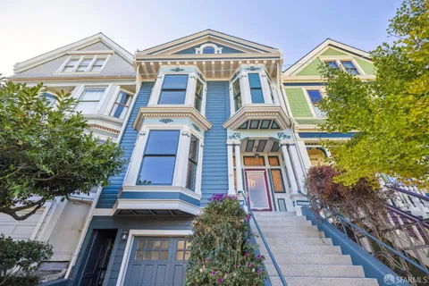a front view of a residential houses with yard