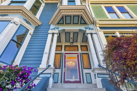 a view of a dining room with furniture wooden floor and a chandelier