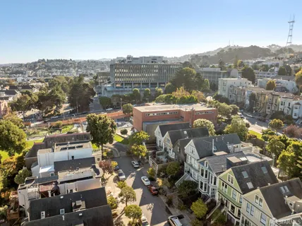 an aerial view of a house with a yard