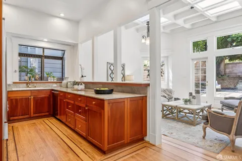 a view of a livingroom with wooden floor and a fireplace