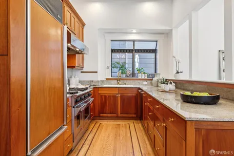 a bedroom with a bed a couch and a flat tv screen on dresser