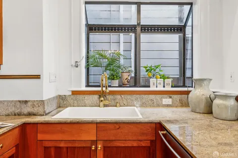 a bedroom with a bed wooden floor and a window
