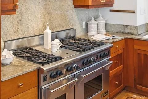 a living room with furniture a fireplace and a window