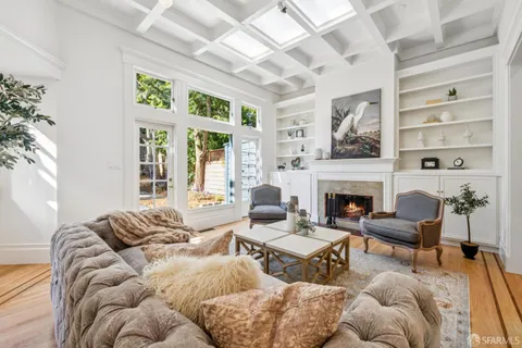 a view of a patio with a table and chairs with wooden fence