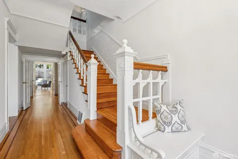 a living room with furniture a window and painting on the wall