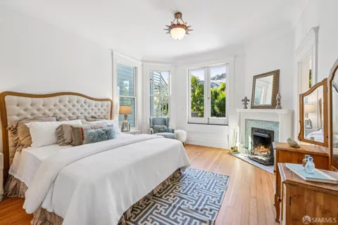 a bed sitting in a bedroom next to a window