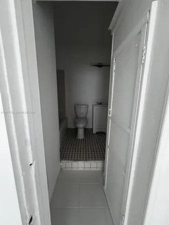 a view of a bathroom from a hallway