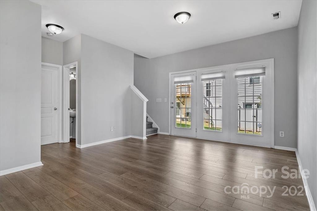 6323 Gammon Road Charlotte, NC 28269 - Photo 14 of 28 wooden floor in an empty room with a window