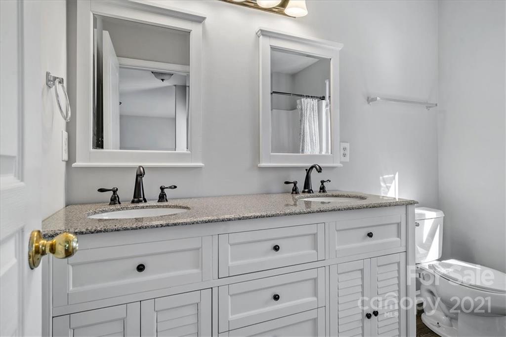 6323 Gammon Road Charlotte, NC 28269 - Photo 22 of 28 a bathroom with a granite countertop sink and a mirror