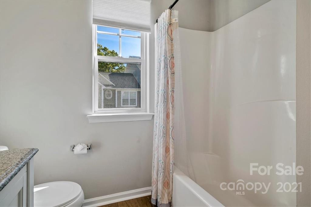 6323 Gammon Road Charlotte, NC 28269 - Photo 23 of 28 a bathroom with a window and a toilet