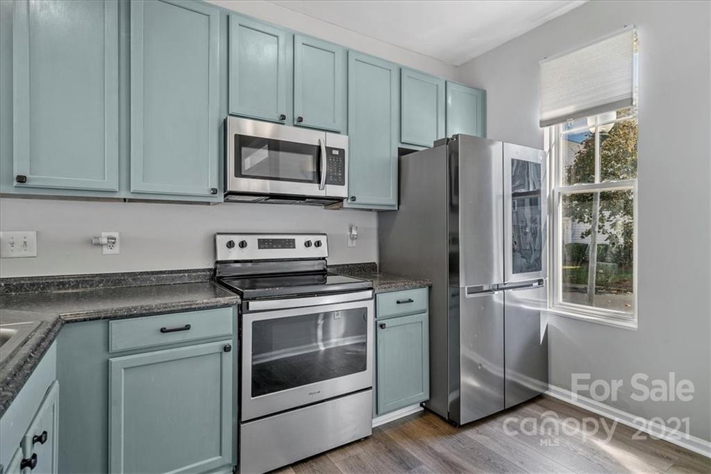 6323 Gammon Road Charlotte, NC 28269 - Photo 4 of 28 a kitchen with stainless steel appliances granite countertop a refrigerator stove and microwave