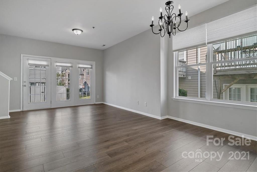 6323 Gammon Road Charlotte, NC 28269 - Photo 8 of 28 a view of an empty room with window and wooden floor