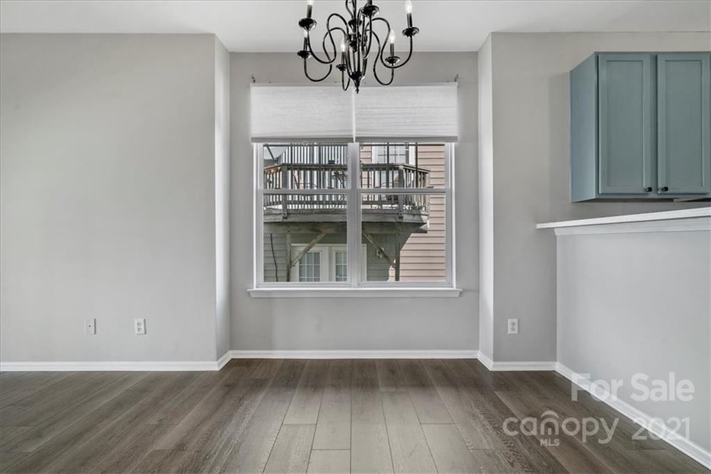 6323 Gammon Road Charlotte, NC 28269 - Photo 9 of 28 a view of empty room with wooden floor and fan