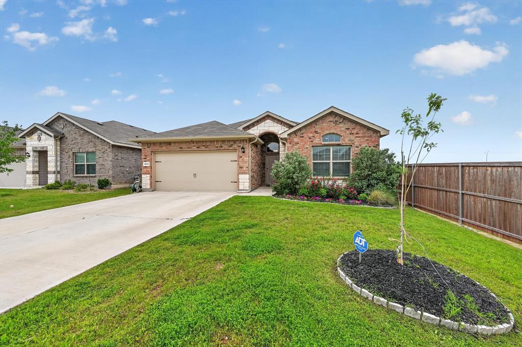 9604 Cherryville Road Fort Worth, TX 76108 - Photo 2 of 40 Brick exterior with stone accents, an arched entry, and an integrated two-car garage