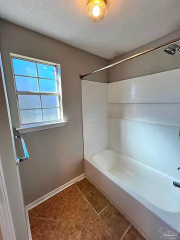 a bathroom with a bathtub and shower