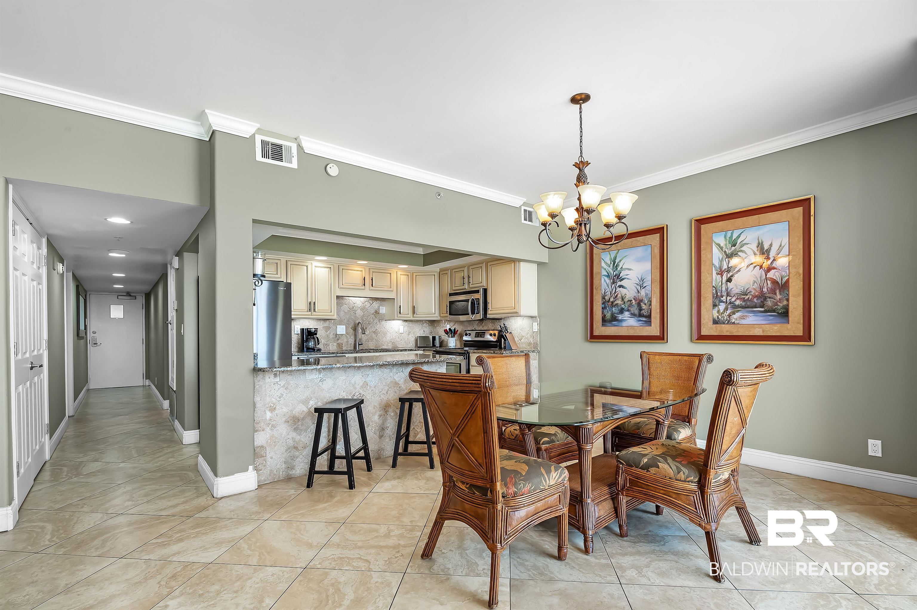 16287 Perdido Key Drive, Unit 105 Pensacola, FL 32507 - Photo 13 of 66 Expansive dining area featuring a chandelier, tile flooring, and crown molding
