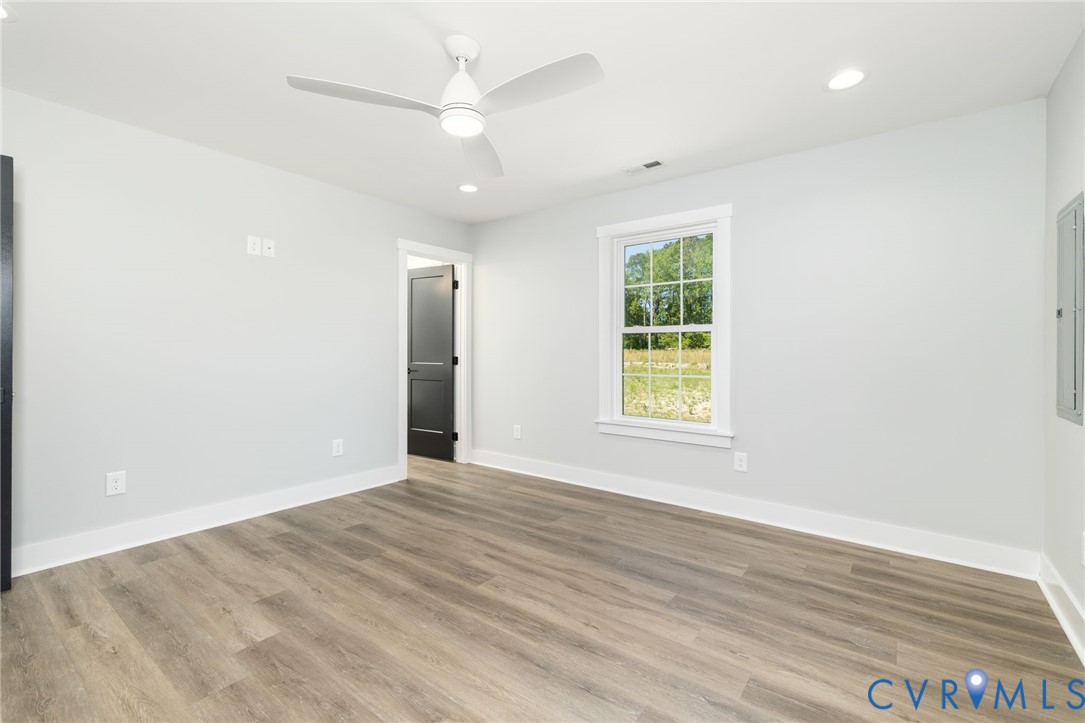 2085 Skippers Road Emporia, VA 23847 - Photo 12 of 34 an empty room with wooden floor and windows