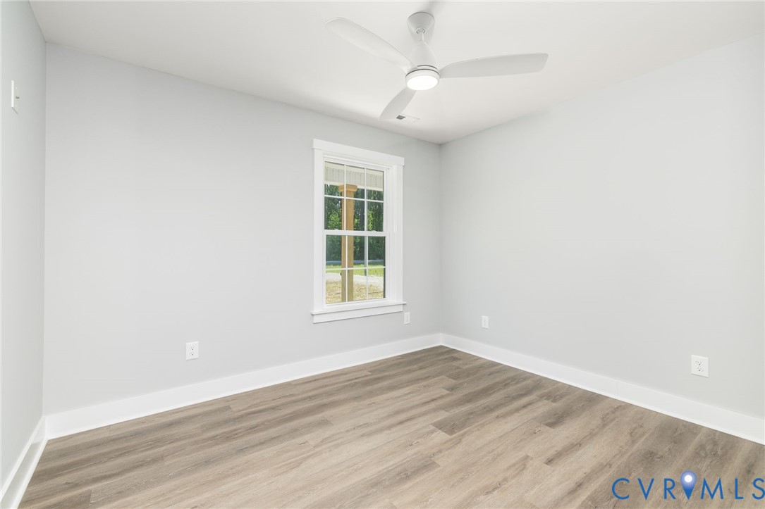 2085 Skippers Road Emporia, VA 23847 - Photo 17 of 34 an empty room with wooden floor and windows