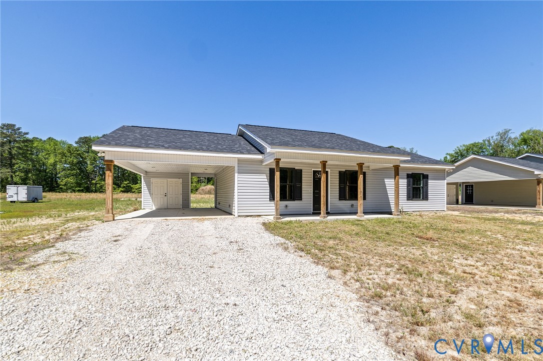 2085 Skippers Road Emporia, VA 23847 - Photo 25 of 34 a front view of a house with a garden and yard