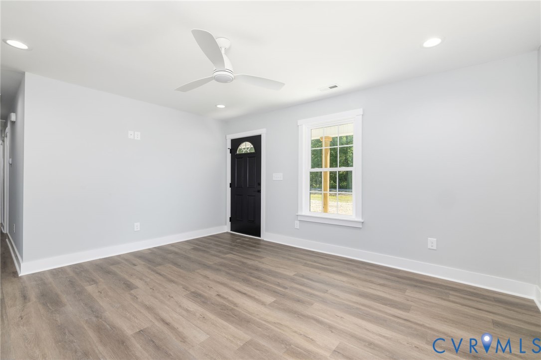 2085 Skippers Road Emporia, VA 23847 - Photo 4 of 34 an empty room with wooden floor and windows