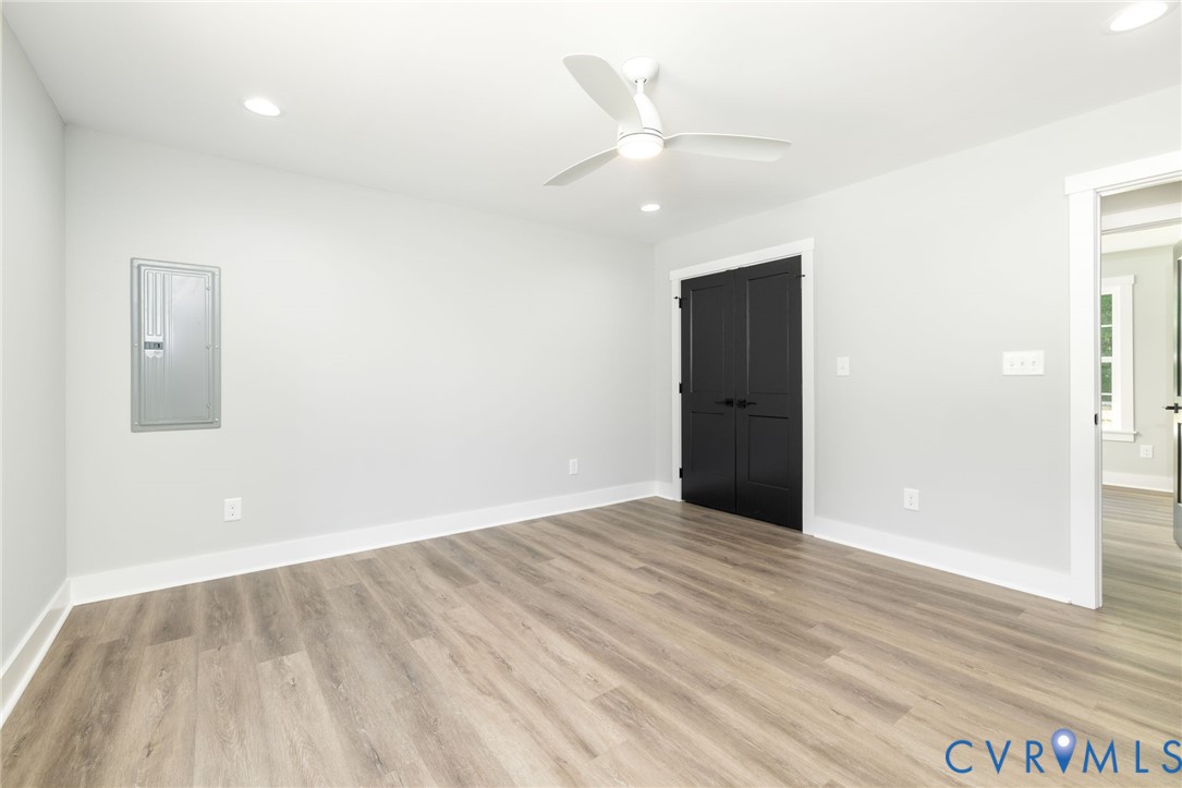 2085 Skippers Road Emporia, VA 23847 - Photo 5 of 34 an empty room with wooden floor and windows