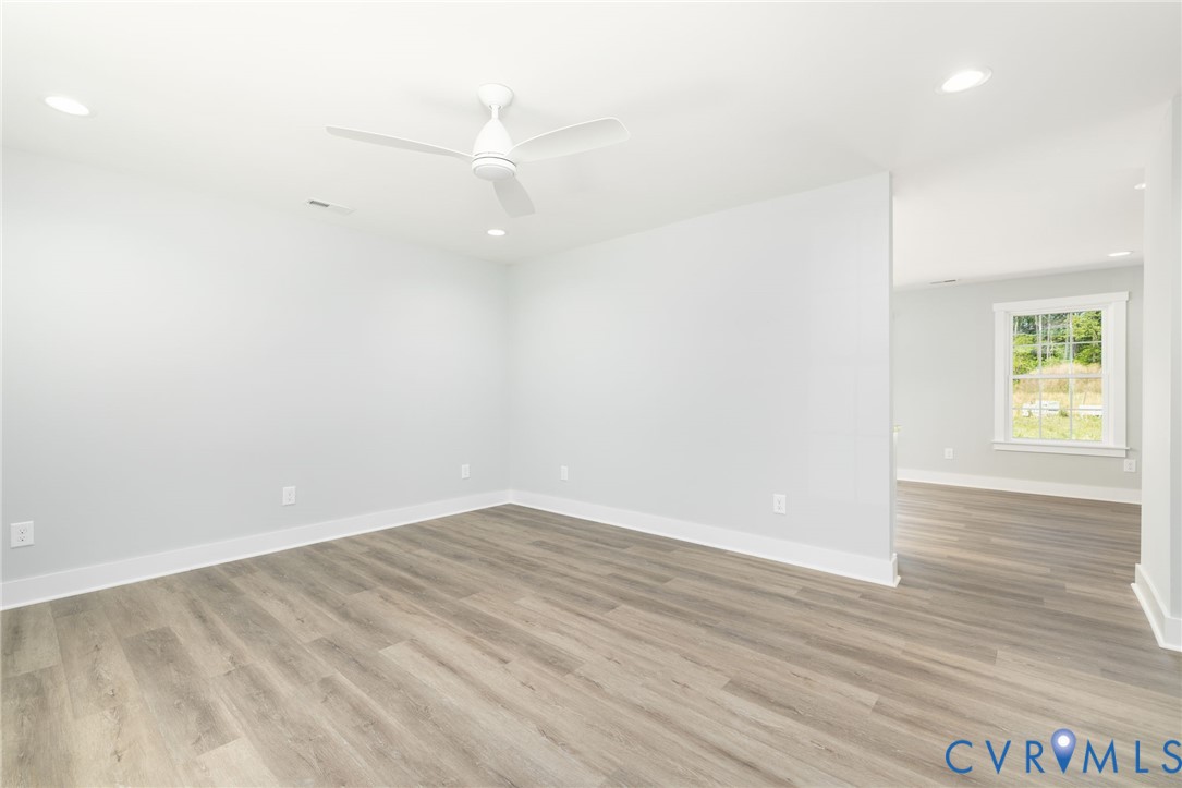 2085 Skippers Road Emporia, VA 23847 - Photo 6 of 34 an empty room with wooden floor and windows