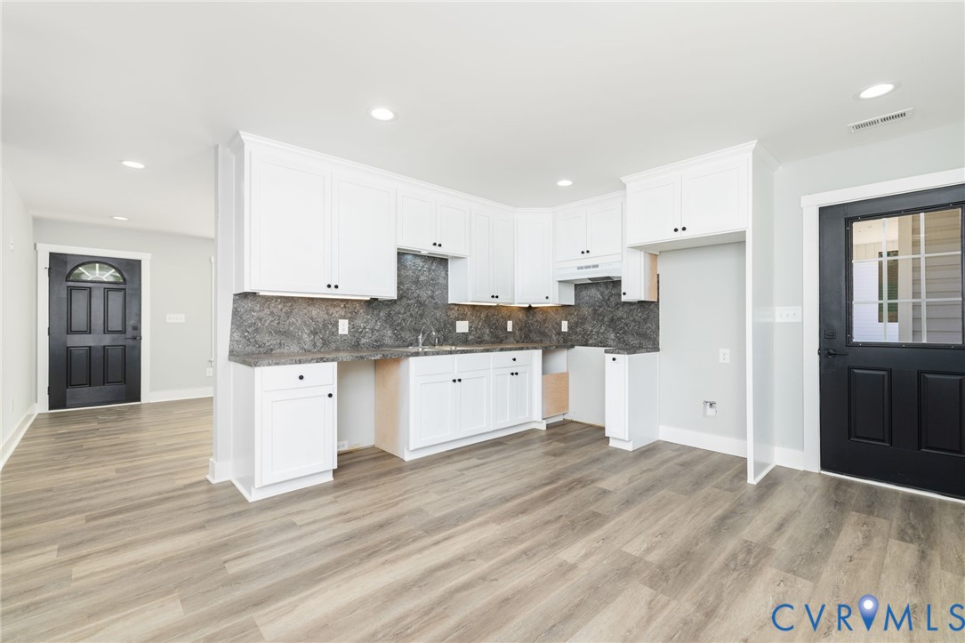 2085 Skippers Road Emporia, VA 23847 - Photo 7 of 34 a large kitchen with granite countertop a stove a sink and a refrigerator