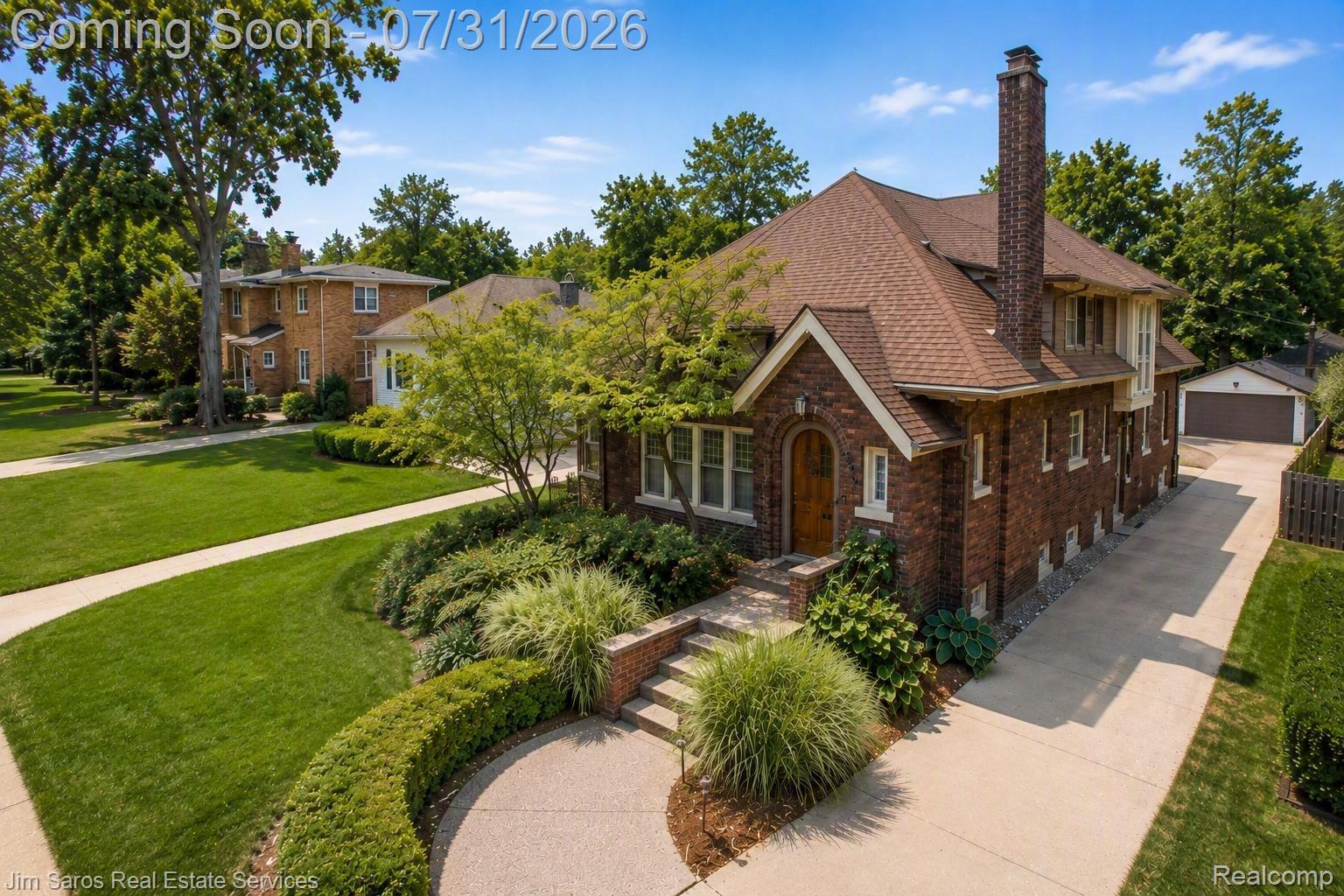 Brick exterior with an arched wooden entry door and an extended chimney