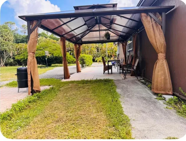 a view of yard with patio