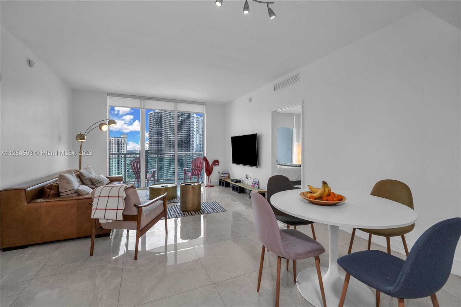 Brickell Miami, FL 33131 - Photo 1 of 29 a living room with furniture and a flat screen tv