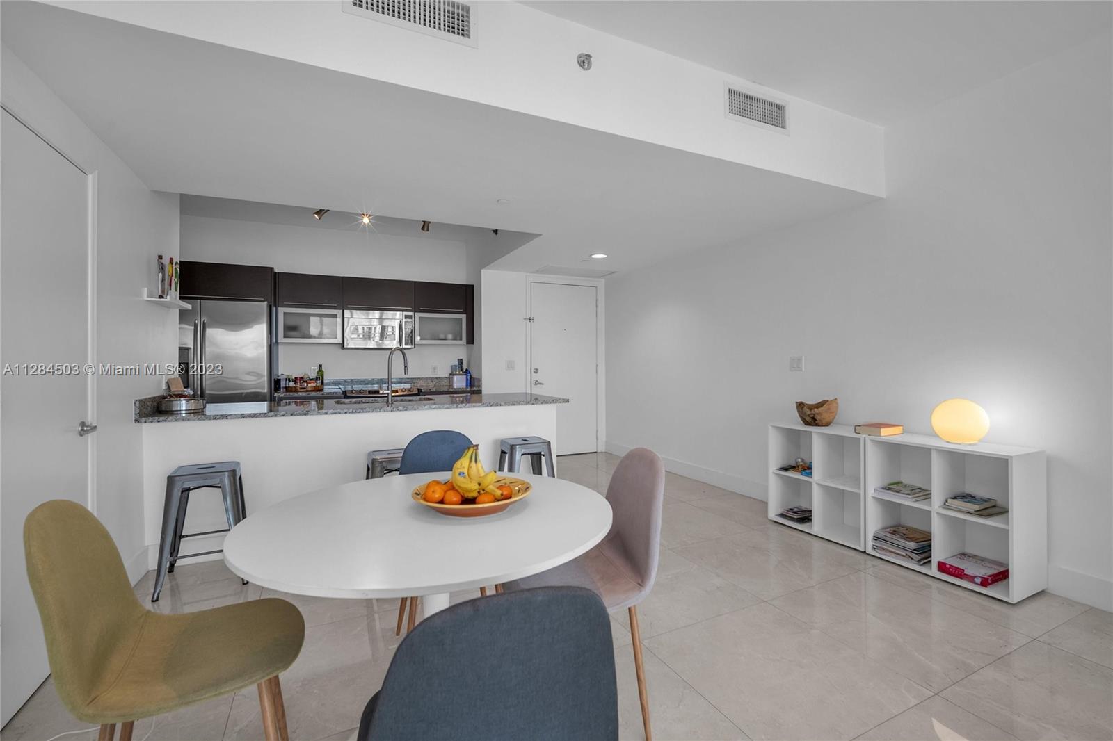 Brickell Miami, FL 33131 - Photo 11 of 29 a kitchen with a table and chairs in it