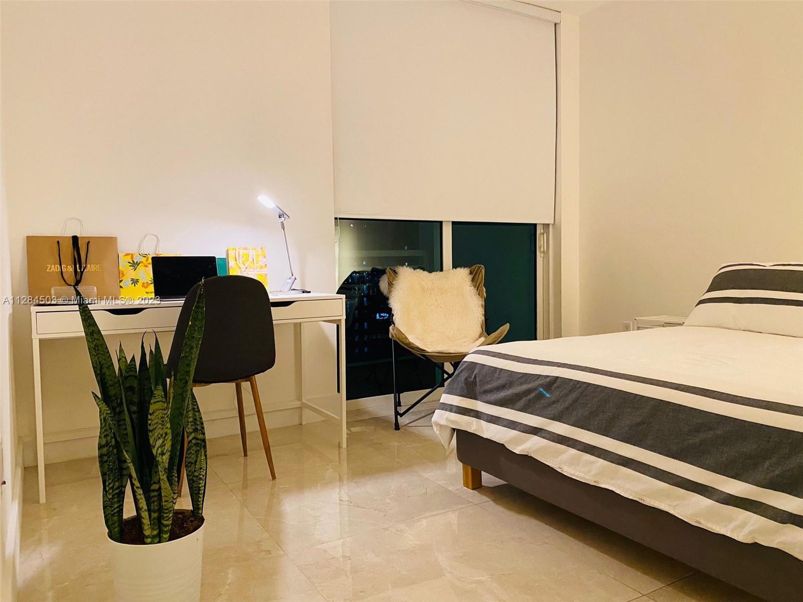 Brickell Miami, FL 33131 - Photo 15 of 29 a bedroom with a bed and chair