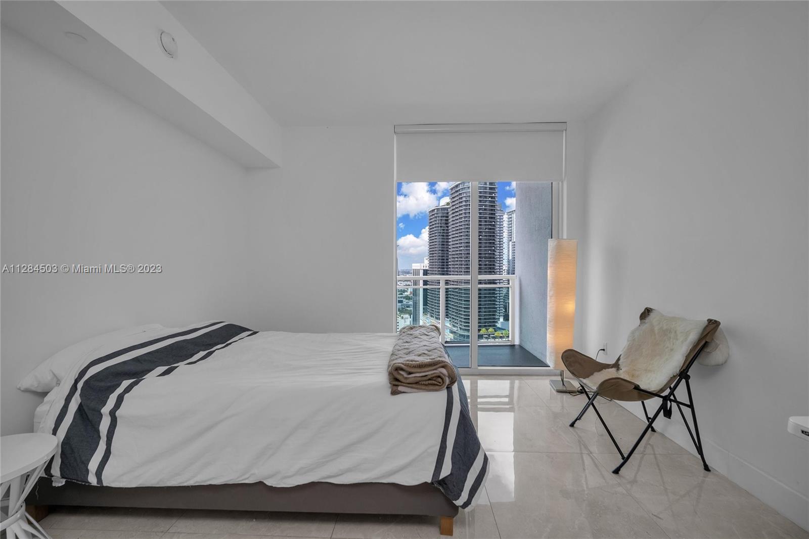 Brickell Miami, FL 33131 - Photo 16 of 29 a bedroom with a bed and window