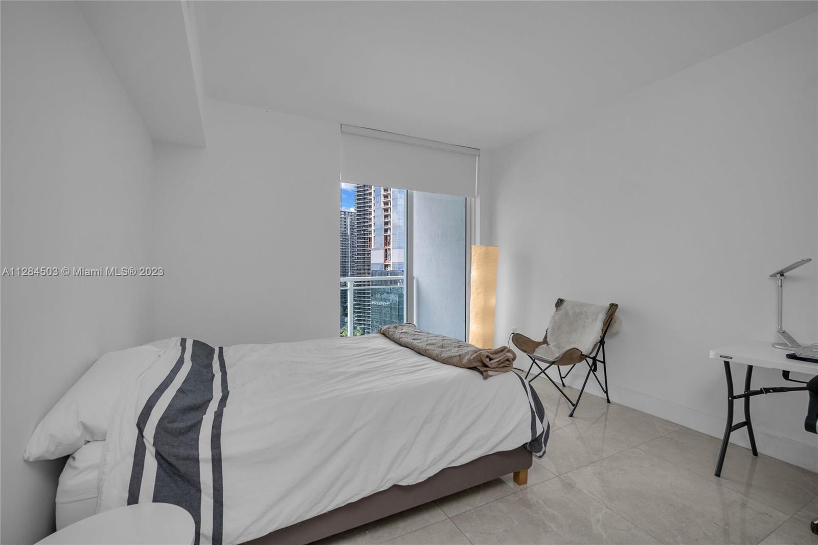 Brickell Miami, FL 33131 - Photo 17 of 29 a bedroom with a bed chair and window