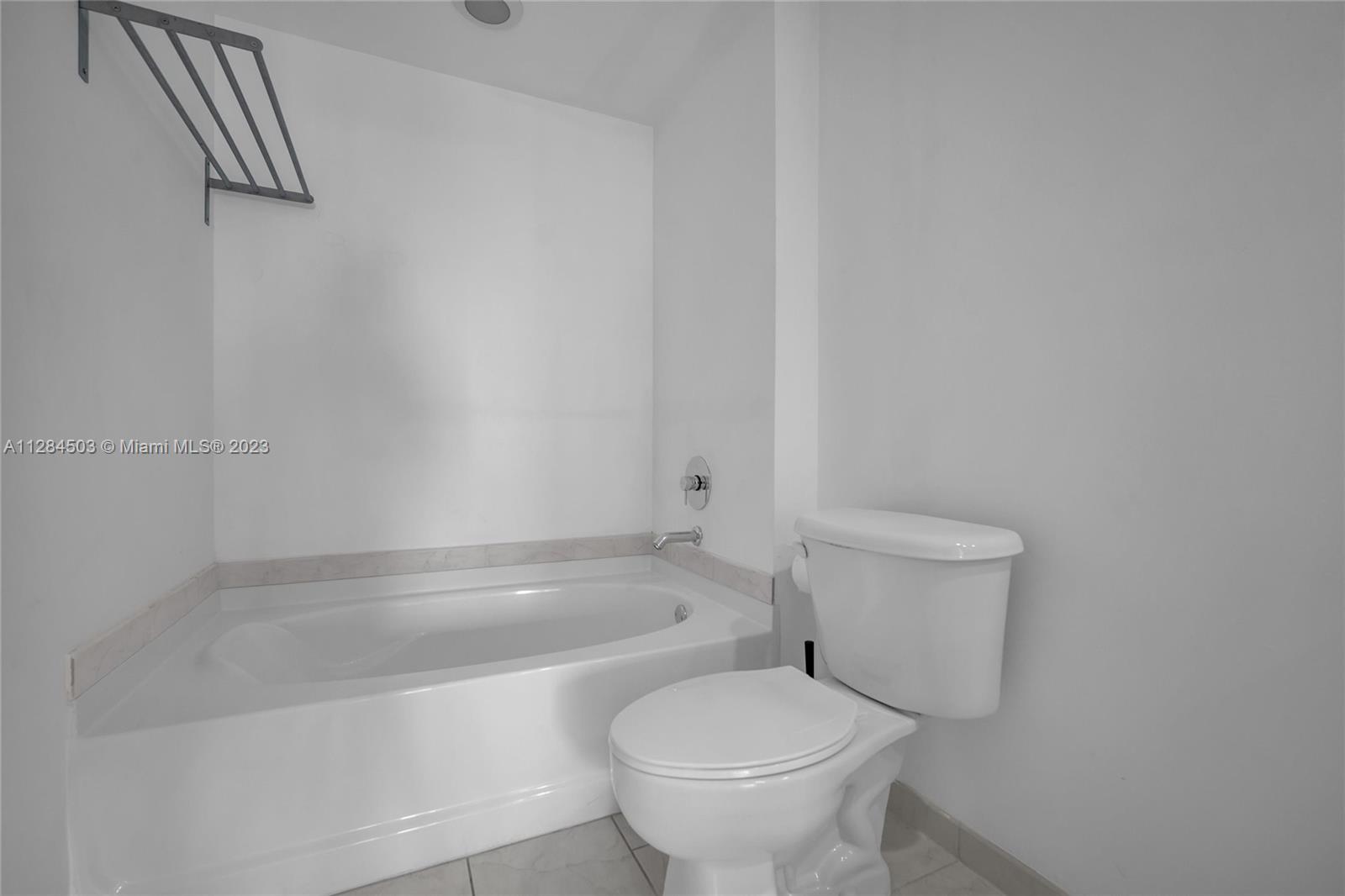 Brickell Miami, FL 33131 - Photo 19 of 29 a white toilet sitting next to a bath tub