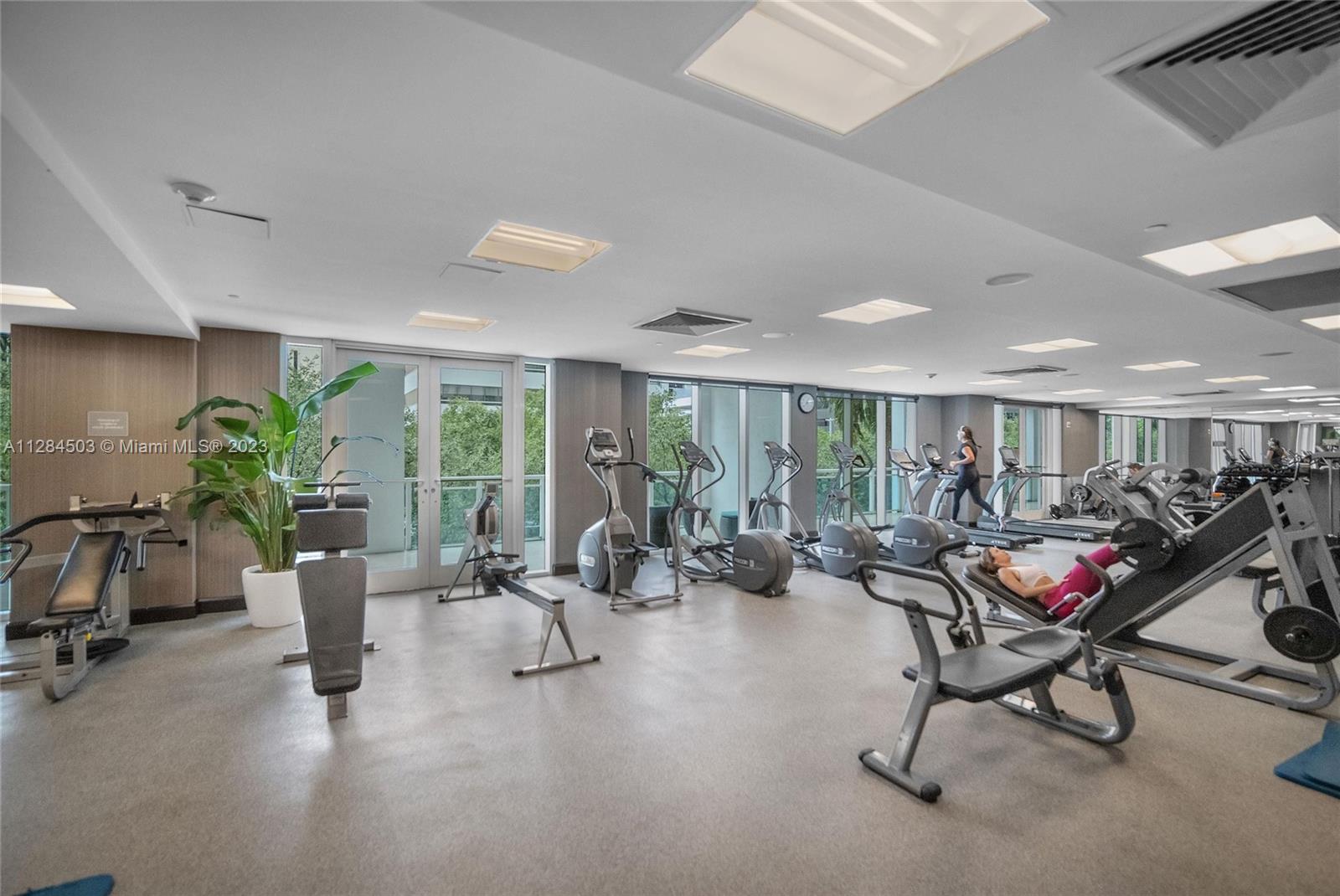 Brickell Miami, FL 33131 - Photo 25 of 29 a living room with furniture gym equipment and floor to ceiling window