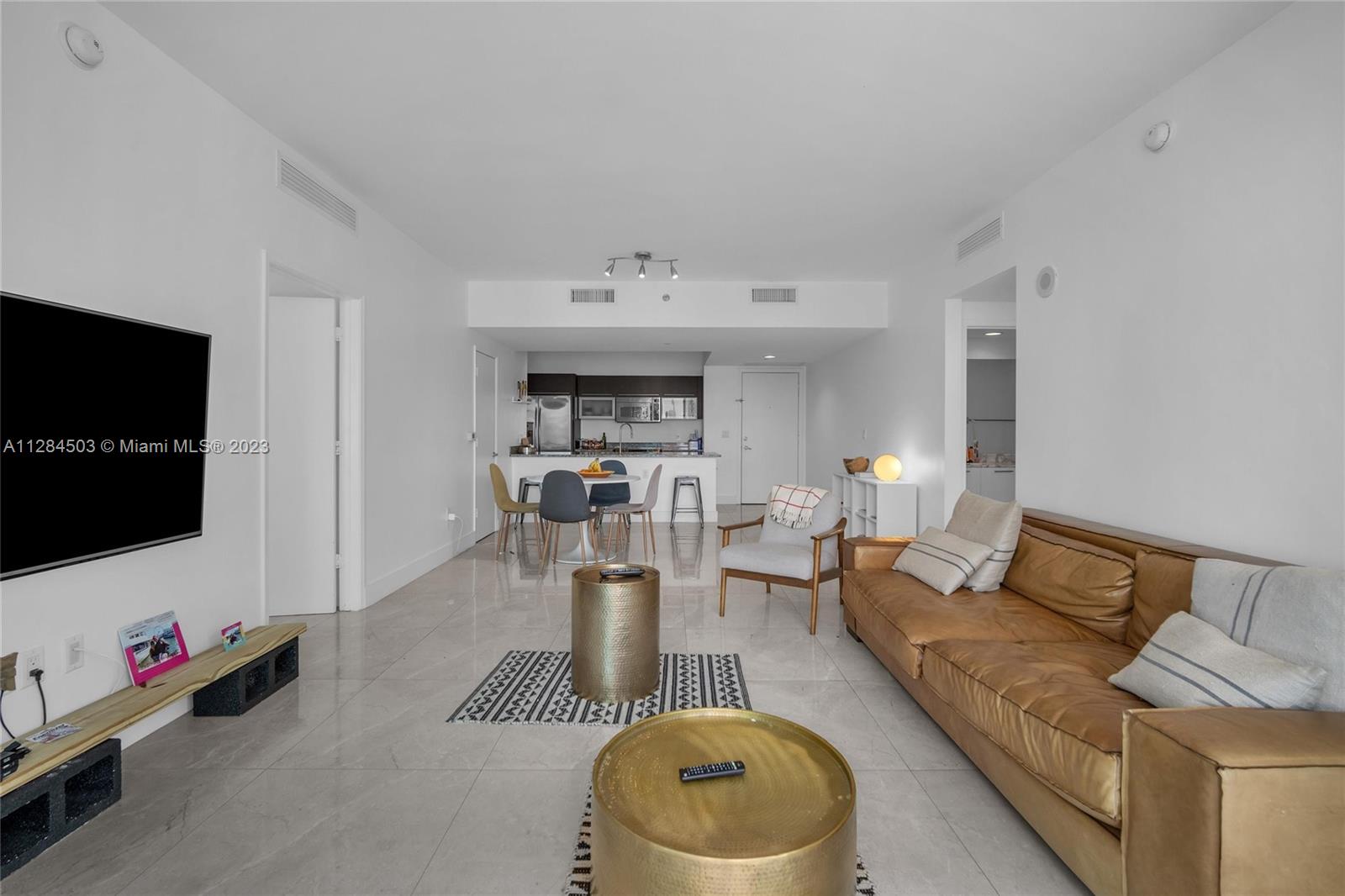 Brickell Miami, FL 33131 - Photo 4 of 29 a living room with furniture and a flat screen tv